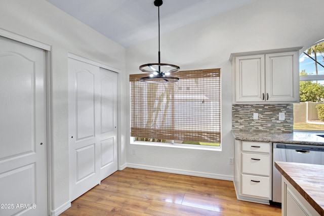 811 S Pearl Dr, Gilbert, AZ 85233 - kitchen featuring stainless steel dishwasher, decorative backsplash, butcher block counters, light wood-style flooring, and baseboards