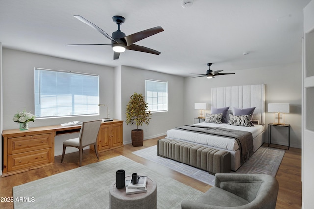 811 S Pearl Dr, Gilbert, AZ 85233 - bedroom with a ceiling fan, built in study area, and light wood-style floors