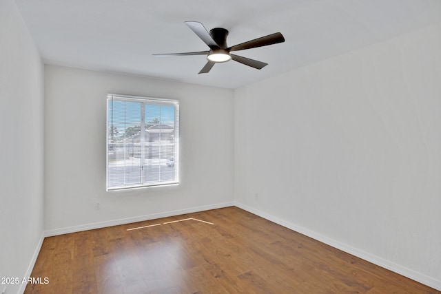 811 S Pearl Dr, Gilbert, AZ 85233 - unfurnished room with wood finished floors, a ceiling fan, and baseboards