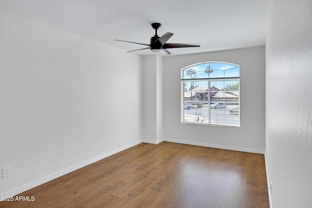 811 S Pearl Dr, Gilbert, AZ 85233 - spare room featuring baseboards, a ceiling fan, and wood finished floors