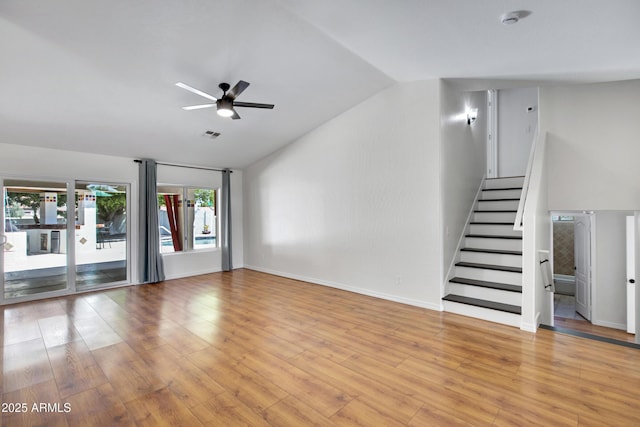 811 S Pearl Dr, Gilbert, AZ 85233 - unfurnished living room with lofted ceiling, a ceiling fan, light wood finished floors, and stairway