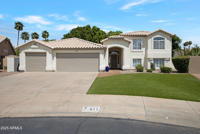 811 S Pearl Dr, Gilbert, AZ 85233 - mediterranean / spanish-style home featuring an attached garage, a tile roof, a front yard, and concrete driveway