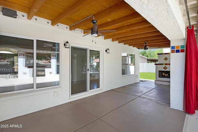 811 S Pearl Dr, Gilbert, AZ 85233 - view of patio / terrace featuring a warm lit fireplace and ceiling fan