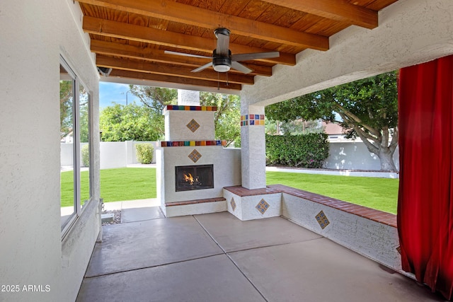 811 S Pearl Dr, Gilbert, AZ 85233 - view of patio / terrace with ceiling fan, a fenced backyard, and a lit fireplace