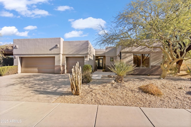 pueblo-style home with a garage