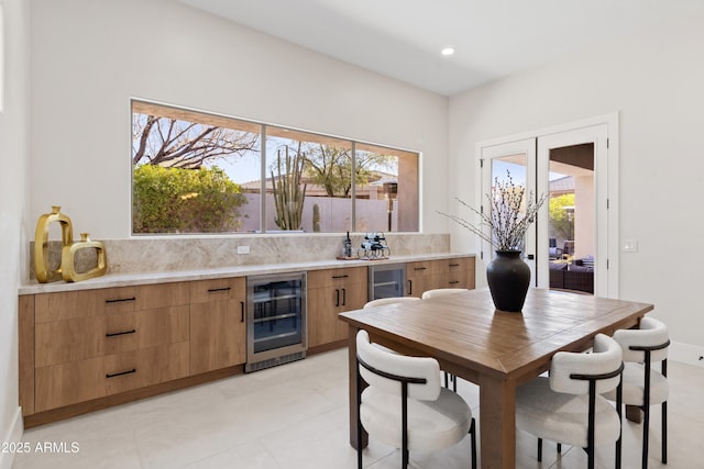 interior space with wine cooler, backsplash, and plenty of natural light