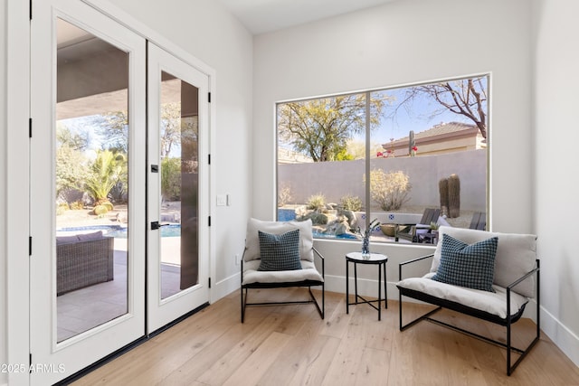 interior space with french doors and light hardwood / wood-style floors