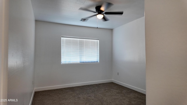 empty room with dark colored carpet, baseboards, and ceiling fan