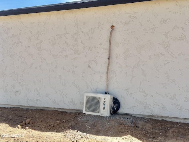 exterior view of stucco siding and a cooling unit