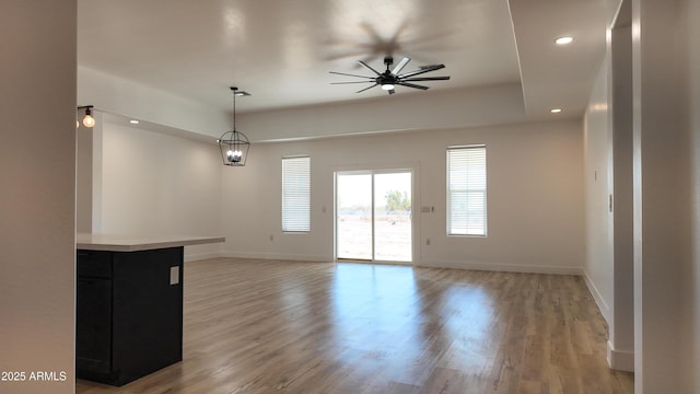 unfurnished room with ceiling fan, recessed lighting, baseboards, and light wood-style floors