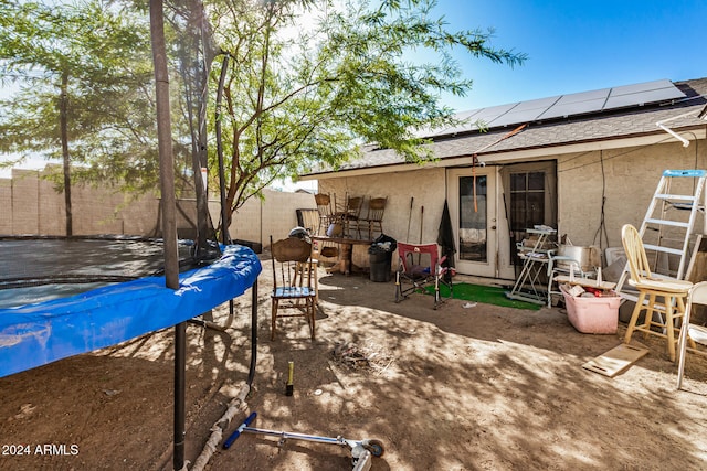 view of patio featuring a pool and a trampoline