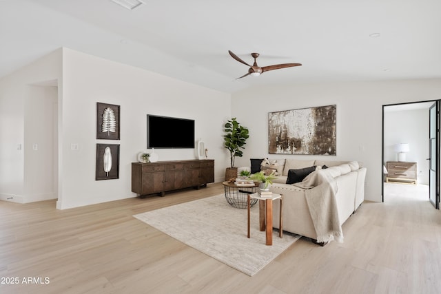 living area featuring lofted ceiling, ceiling fan, and light wood-style flooring