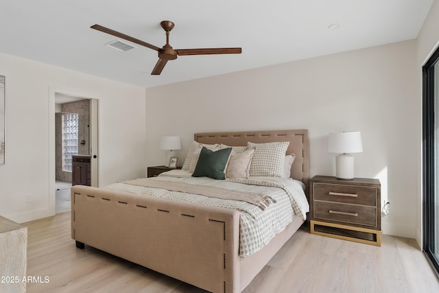 bedroom featuring a ceiling fan, visible vents, light wood-style flooring, and ensuite bathroom