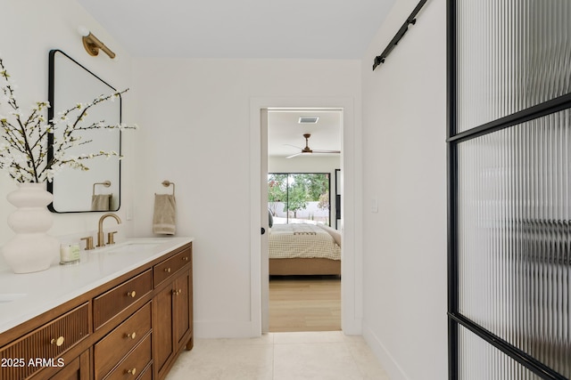 ensuite bathroom with visible vents, connected bathroom, vanity, tile patterned flooring, and baseboards