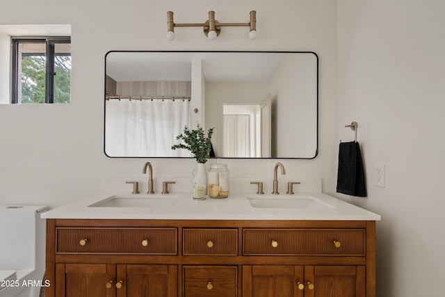 bathroom featuring double vanity and a sink