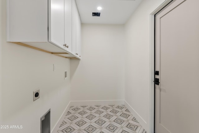 laundry room featuring cabinet space, electric dryer hookup, and baseboards