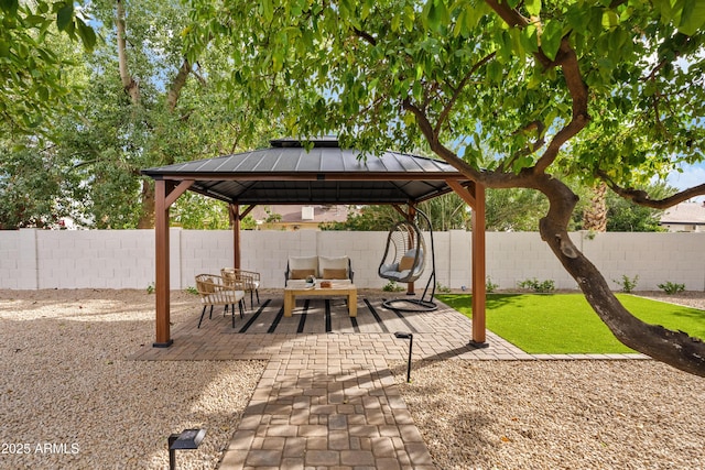 view of patio / terrace featuring a fenced backyard, outdoor lounge area, and a gazebo