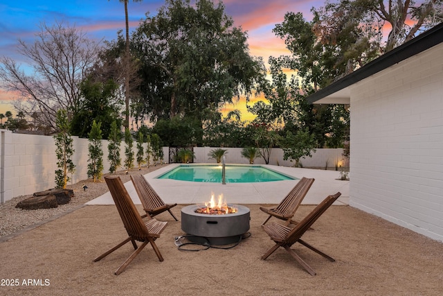 view of pool with a fire pit, a patio area, a fenced backyard, and a fenced in pool