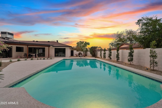 view of pool with a patio area, a fenced backyard, a fenced in pool, and central air condition unit