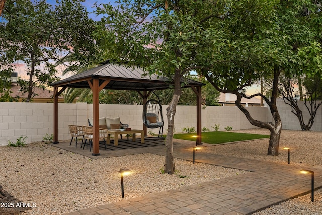 exterior space featuring a fenced backyard and a gazebo