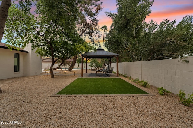 view of yard featuring a patio area, a fenced backyard, and a gazebo