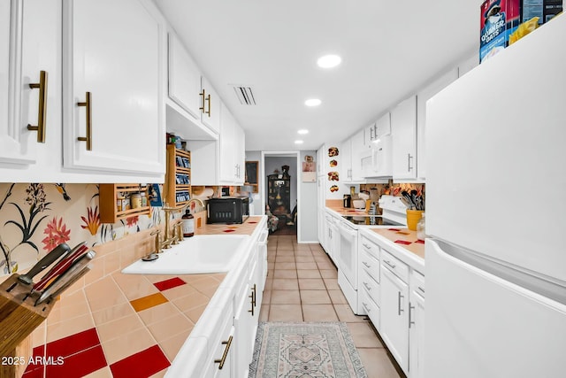 1924 W Belmont Ave, Phoenix, AZ 85021 - kitchen featuring tile counters, white appliances, white cabinets, visible vents, and recessed lighting