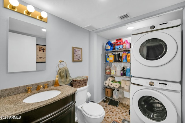 1924 W Belmont Ave, Phoenix, AZ 85021 - bathroom with stacked washer / drying machine, visible vents, toilet, and vanity