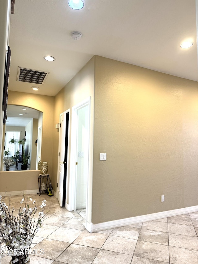 hallway with light tile patterned flooring