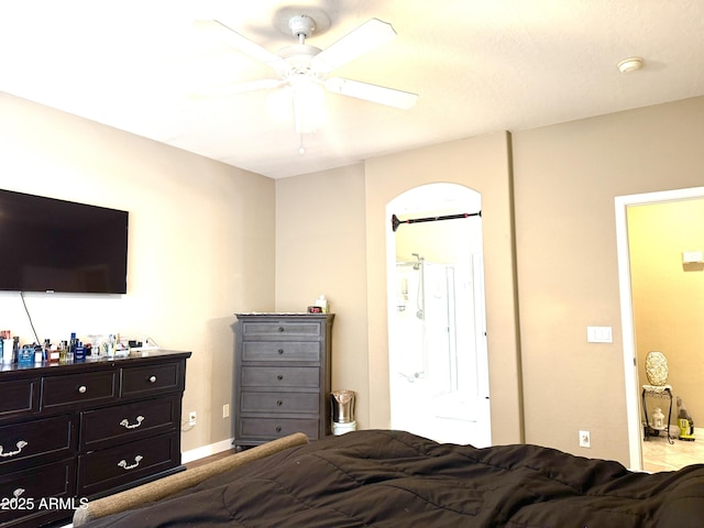 bedroom featuring ensuite bath and ceiling fan