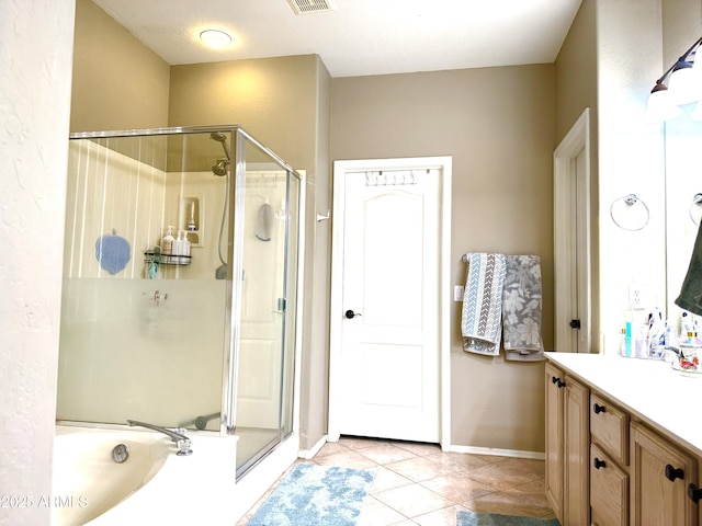 bathroom featuring tile patterned flooring, vanity, and shower with separate bathtub