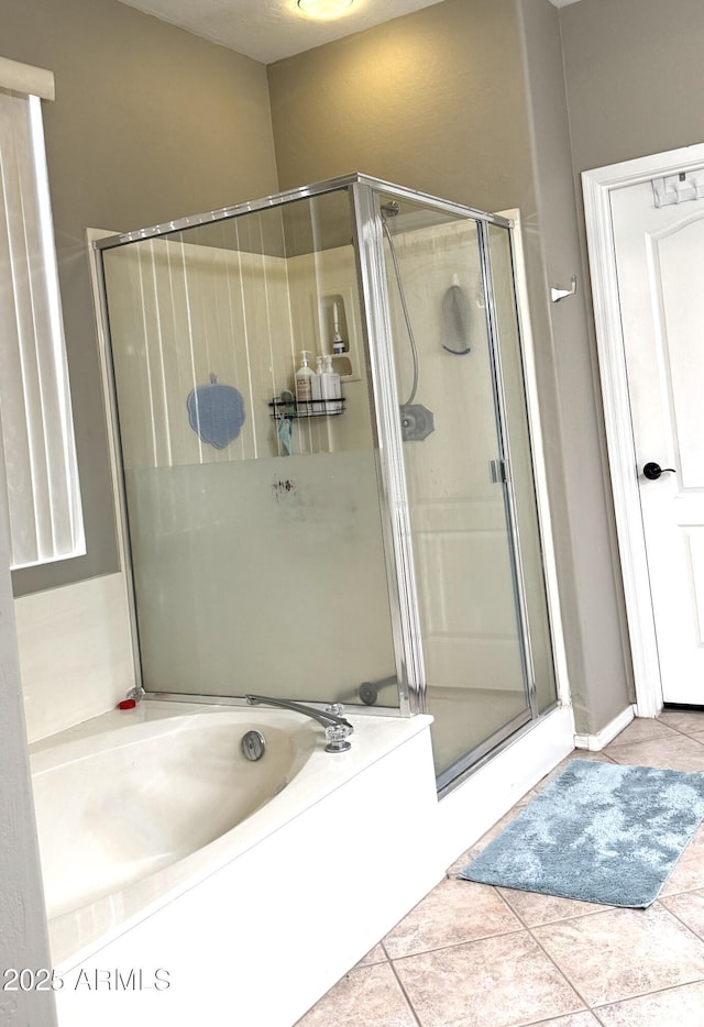 bathroom featuring tile patterned floors and independent shower and bath