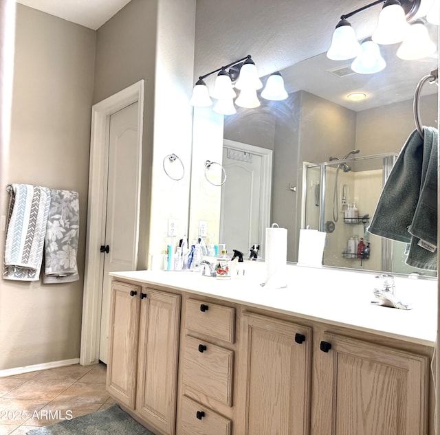 bathroom with tile patterned floors, a shower with shower door, and vanity