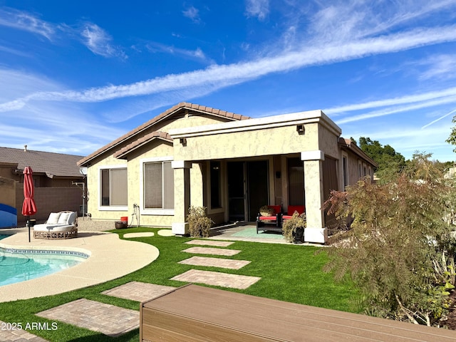 rear view of house with a yard and a patio