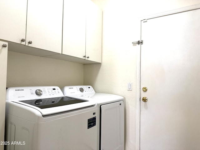 laundry room featuring cabinets and separate washer and dryer