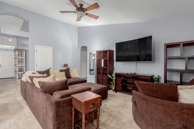 living room with ceiling fan, light colored carpet, and lofted ceiling