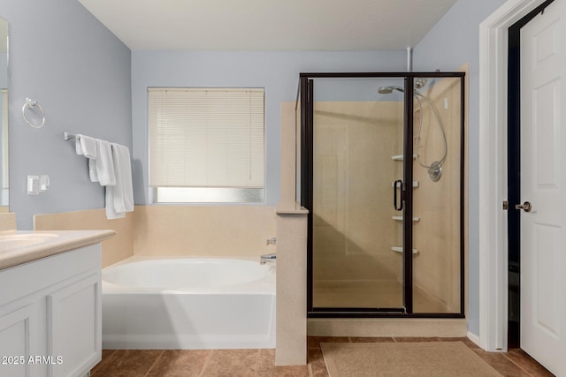 bathroom featuring tile patterned flooring, vanity, and shower with separate bathtub