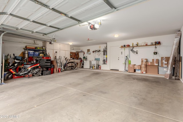 garage with water heater and a garage door opener