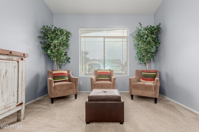 living area with plenty of natural light and light carpet