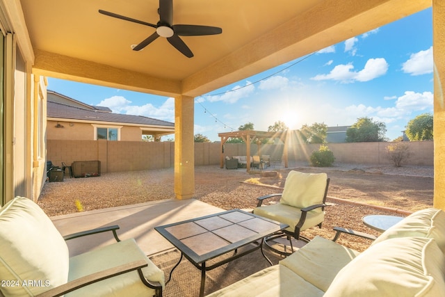 view of patio / terrace featuring ceiling fan, an outdoor living space, and a pergola