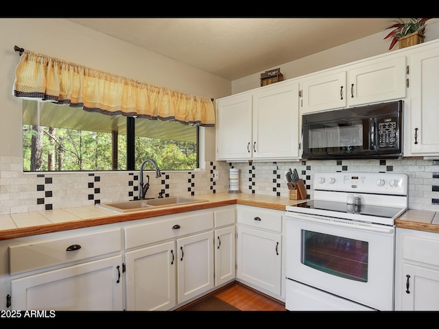 6869 W Ute Trl, Pine, AZ 85544 - kitchen featuring black microwave, white electric stove, a sink, decorative backsplash, and white cabinetry
