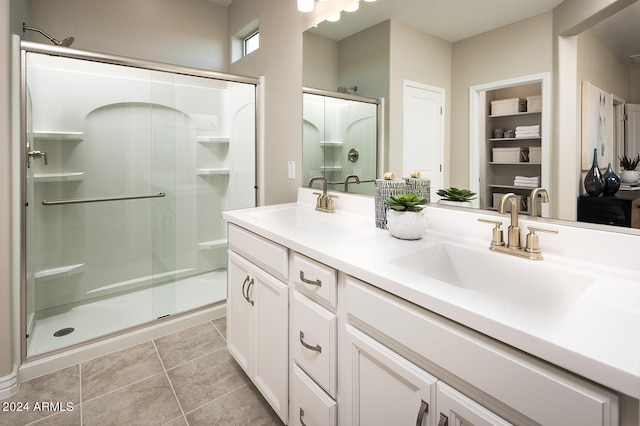 bathroom with walk in shower, tile flooring, and double vanity