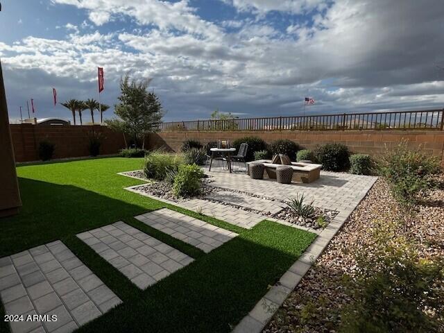 view of yard featuring a fire pit and a patio area