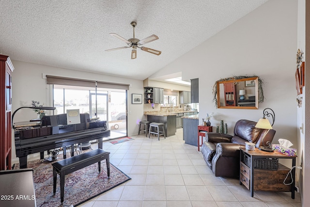 tiled living room with ceiling fan, lofted ceiling, and a textured ceiling