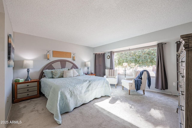 bedroom with light colored carpet and a textured ceiling