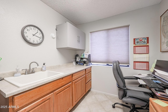 home office with sink and a textured ceiling