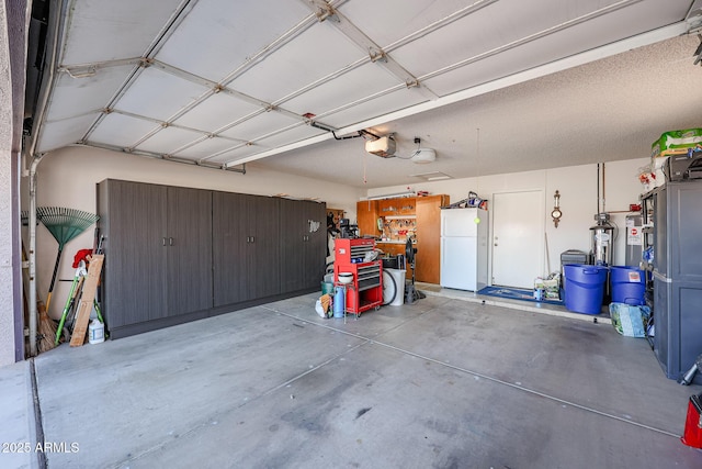 garage featuring a garage door opener and white refrigerator