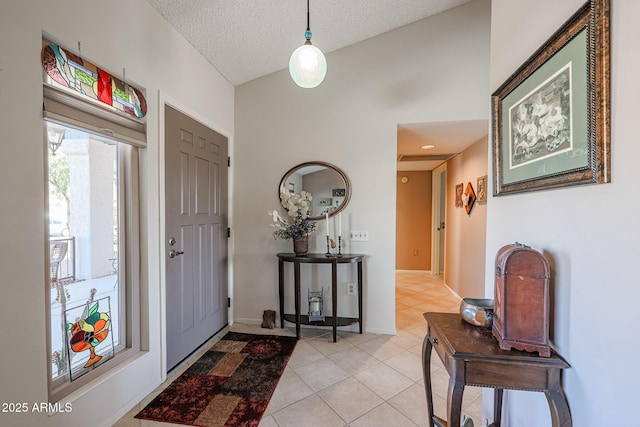 tiled foyer featuring a textured ceiling