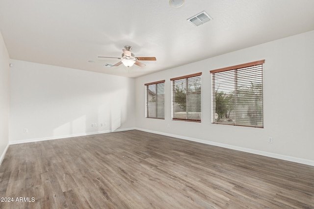 spare room featuring hardwood / wood-style flooring and ceiling fan