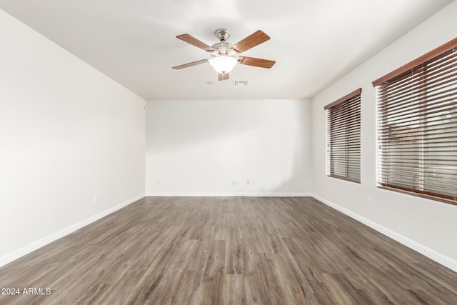 empty room with dark hardwood / wood-style floors and ceiling fan