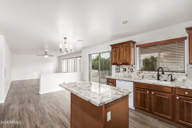 kitchen with decorative backsplash, sink, decorative light fixtures, dishwasher, and a center island